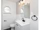 Bright renovated bathroom featuring stylish white subway tile and gray flooring at 1622 N Linwood Ave, Indianapolis, IN 46218