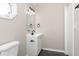 A charming bathroom with a vanity, mirror, and a unique light fixture, featuring a window at 1622 N Linwood Ave, Indianapolis, IN 46218