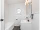 Bright renovated bathroom featuring stylish white subway tile and gray flooring at 1622 N Linwood Ave, Indianapolis, IN 46218