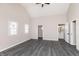 A stylish bedroom with gray walls, gray wood-look vinyl floors, and a view of the bathroom at 1622 N Linwood Ave, Indianapolis, IN 46218