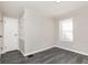 Bedroom featuring modern gray vinyl flooring, a bright window, and closet at 1622 N Linwood Ave, Indianapolis, IN 46218