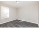 Spacious bedroom featuring modern gray vinyl flooring and a bright window at 1622 N Linwood Ave, Indianapolis, IN 46218