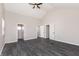 A bright bedroom with gray walls and gray wood-look vinyl floors, featuring a vaulted ceiling and ceiling fan at 1622 N Linwood Ave, Indianapolis, IN 46218