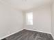 Bedroom featuring modern gray vinyl flooring and a bright window at 1622 N Linwood Ave, Indianapolis, IN 46218