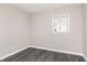 A charming bedroom featuring gray walls and gray wood-look vinyl floors, complemented by a bright window at 1622 N Linwood Ave, Indianapolis, IN 46218