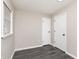 A simple bedroom with gray walls and gray wood-look vinyl floors, enhanced by two white doors at 1622 N Linwood Ave, Indianapolis, IN 46218
