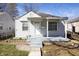 Inviting front porch and siding details add curb appeal to this charming home at 1622 N Linwood Ave, Indianapolis, IN 46218