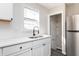 Bright kitchen featuring quartz countertops, white subway tile backsplash, and stainless steel appliances at 1622 N Linwood Ave, Indianapolis, IN 46218