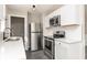 Modern kitchen featuring white cabinets, quartz countertops, and stainless steel appliances at 1622 N Linwood Ave, Indianapolis, IN 46218