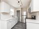 Modern kitchen featuring white cabinets, quartz countertops, and stainless steel appliances at 1622 N Linwood Ave, Indianapolis, IN 46218