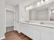 Bathroom featuring double vanity with a large mirror and bright lighting at 16429 Mount Logan Rd, Noblesville, IN 46060