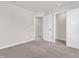 Bedroom featuring gray carpet, white trim, and neutral colored walls with two doorways at 16429 Mount Logan Rd, Noblesville, IN 46060