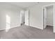 This bedroom offers ample space, neutral walls, carpeted floor, and features two doorways with great natural light at 16429 Mount Logan Rd, Noblesville, IN 46060