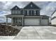 Two-story home showcasing a three car garage and a stylish gray exterior at 16429 Mount Logan Rd, Noblesville, IN 46060