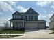 Charming two-story home with two-car garage, well-maintained lawn, and inviting curb appeal at 16429 Mount Logan Rd, Noblesville, IN 46060