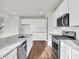 Bright, modern kitchen featuring white cabinets, stainless steel appliances, and a gray countertop at 16429 Mount Logan Rd, Noblesville, IN 46060