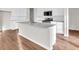 Open kitchen with white cabinets, a center island, and stainless steel appliances at 16429 Mount Logan Rd, Noblesville, IN 46060
