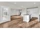 Open-concept kitchen and living area with a central island, modern appliances, and easy access to the backyard at 16429 Mount Logan Rd, Noblesville, IN 46060