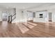 Bright living room with an open layout, modern kitchen, and hardwood floors illuminated by natural light at 16429 Mount Logan Rd, Noblesville, IN 46060