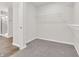 Walk-in closet with carpeted floors, wire shelving, and door leading to bathroom at 16429 Mount Logan Rd, Noblesville, IN 46060