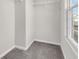 Walk-in closet with gray carpet, white trim, wire shelving and a window at 16429 Mount Logan Rd, Noblesville, IN 46060