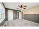 This is a bright bedroom with a ceiling fan, and an attached bathroom at 1721 Rachel Dr, Plainfield, IN 46168