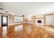 Spacious living room featuring hardwood floors and a cozy brick fireplace at 1721 Rachel Dr, Plainfield, IN 46168