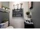 Quirky decorated powder room with board and batten walls and farmhouse accents at 19252 Chestnut Grove Ln, Noblesville, IN 46062
