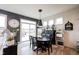 Dining room with black round table set, large windows, decor, and grey accent wall at 19252 Chestnut Grove Ln, Noblesville, IN 46062
