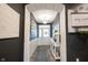 Inviting entryway with decorative archway, neutral walls, and views of front door at 19252 Chestnut Grove Ln, Noblesville, IN 46062