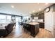 Open-concept kitchen with dark cabinets, light countertops, large island with seating, and modern appliances at 19252 Chestnut Grove Ln, Noblesville, IN 46062