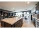 Open concept kitchen and dining area featuring a large island, dark cabinets, and an open layout at 19252 Chestnut Grove Ln, Noblesville, IN 46062