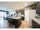 Open kitchen with stainless steel appliances, a large central island with seating, and dark cabinets at 19252 Chestnut Grove Ln, Noblesville, IN 46062