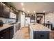 Well-lit kitchen featuring granite countertops, stainless steel appliances, and dark cabinets at 19252 Chestnut Grove Ln, Noblesville, IN 46062