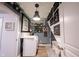 Farmhouse style laundry room featuring string lights, rustic decorations, and modern appliances at 19252 Chestnut Grove Ln, Noblesville, IN 46062