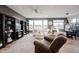 Inviting living room with a cozy chair, decorative bookshelves, and access to the dining area at 19252 Chestnut Grove Ln, Noblesville, IN 46062