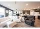 Open-concept living space with kitchen view, inviting furniture, and plenty of natural light at 19252 Chestnut Grove Ln, Noblesville, IN 46062