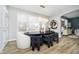 This dining area features modern light fixtures, hardwood floors, and a view of the outdoors at 19966 Chatham Green Dr, Westfield, IN 46074