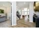 Inviting foyer with views of a staircase and living area, featuring hardwood floors and neutral decor at 19966 Chatham Green Dr, Westfield, IN 46074