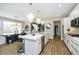Modern kitchen with stainless steel appliances and an island with seating, adjacent to the dining area at 19966 Chatham Green Dr, Westfield, IN 46074