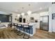Open concept kitchen with stainless steel appliances, kitchen island, and modern lighting at 19966 Chatham Green Dr, Westfield, IN 46074