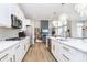 A bright kitchen with white cabinets, stainless steel appliances, and a large island for dining and entertaining at 19966 Chatham Green Dr, Westfield, IN 46074