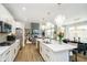 Open concept kitchen with stainless appliances and an island, that opens to the living and dining areas at 19966 Chatham Green Dr, Westfield, IN 46074