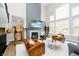 Elegant living area with a fireplace, tall windows, and a unique decorative piece at 19966 Chatham Green Dr, Westfield, IN 46074