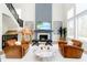Cozy living room with fireplace, large windows, and comfortable seating arrangement at 19966 Chatham Green Dr, Westfield, IN 46074