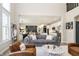 Open-concept living room featuring a comfortable sofa, fireplace and an open view to the kitchen at 19966 Chatham Green Dr, Westfield, IN 46074