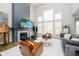 Bright living room with a fireplace, large windows, and comfortable seating arrangement at 19966 Chatham Green Dr, Westfield, IN 46074