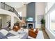 Bright living room with high ceilings, fireplace, comfortable sofa and stylish furnishings at 19966 Chatham Green Dr, Westfield, IN 46074