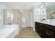 A luxurious bathroom featuring a double vanity, soaking tub, and tiled shower with glass door at 19966 Chatham Green Dr, Westfield, IN 46074