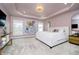 Spacious main bedroom featuring tray ceilings, a statement art piece, and neutral carpet at 19966 Chatham Green Dr, Westfield, IN 46074
